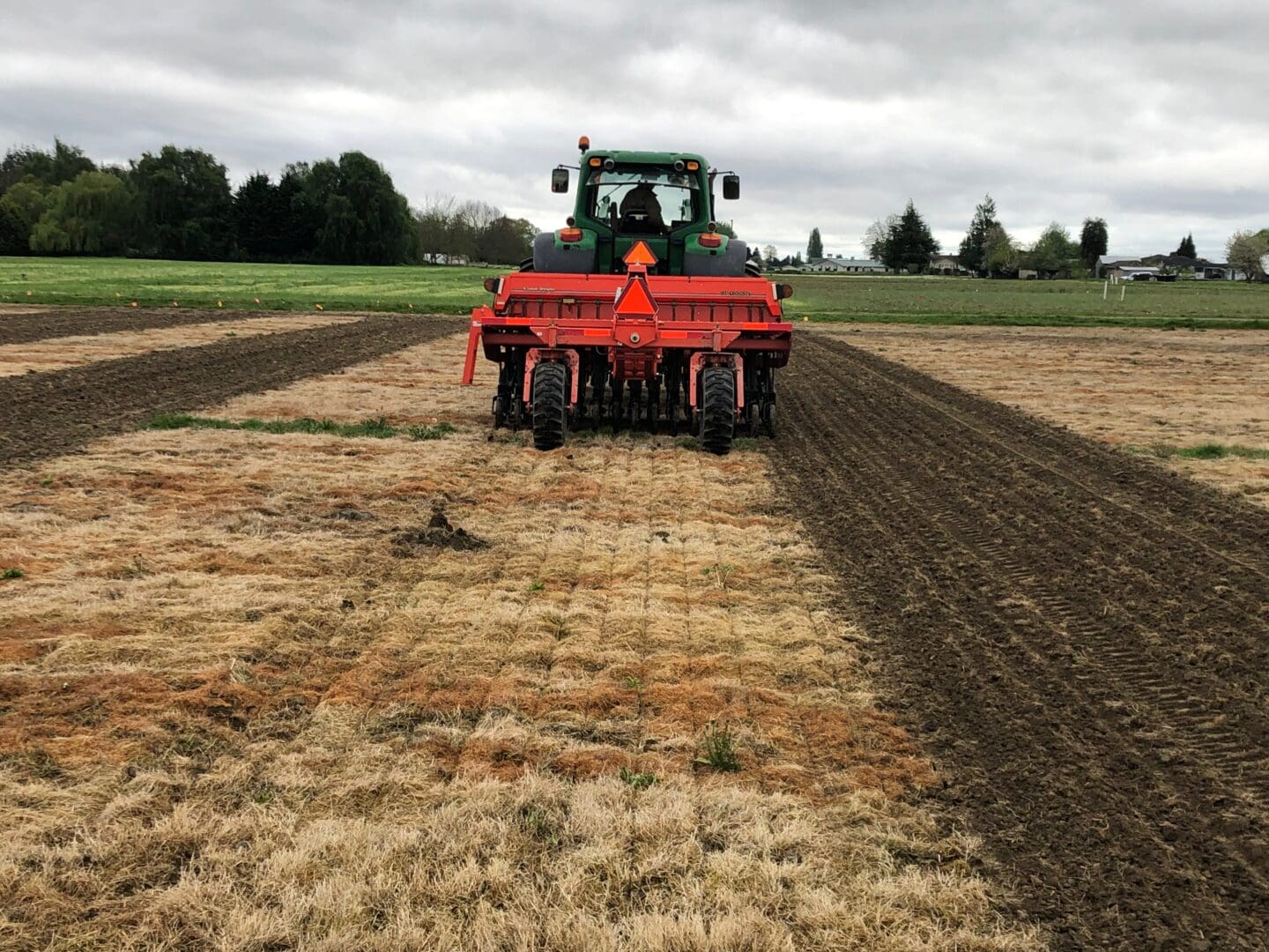 A tractor plowing a field with a plow.