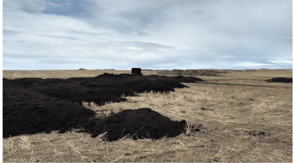 piles of biosolids in a field.