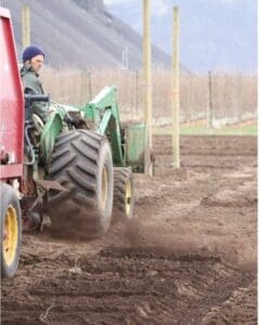 a tractor spreading compost.