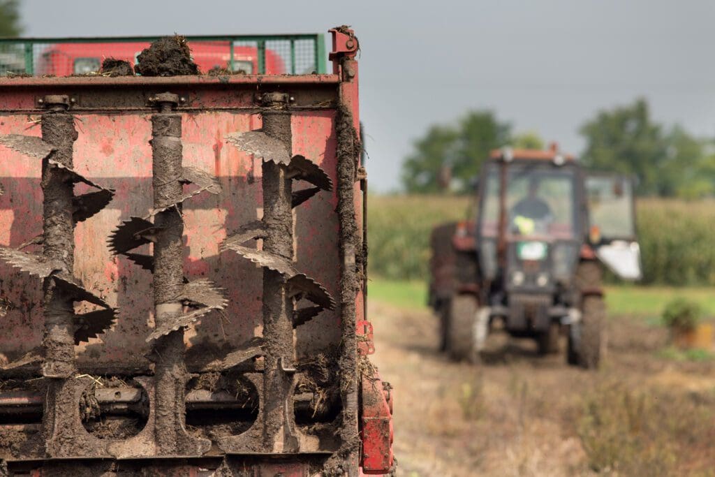 a manure spreader in a field.