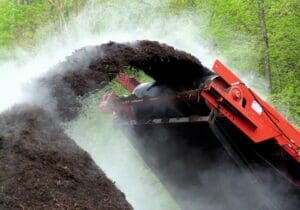 Machinery grinding up compost.