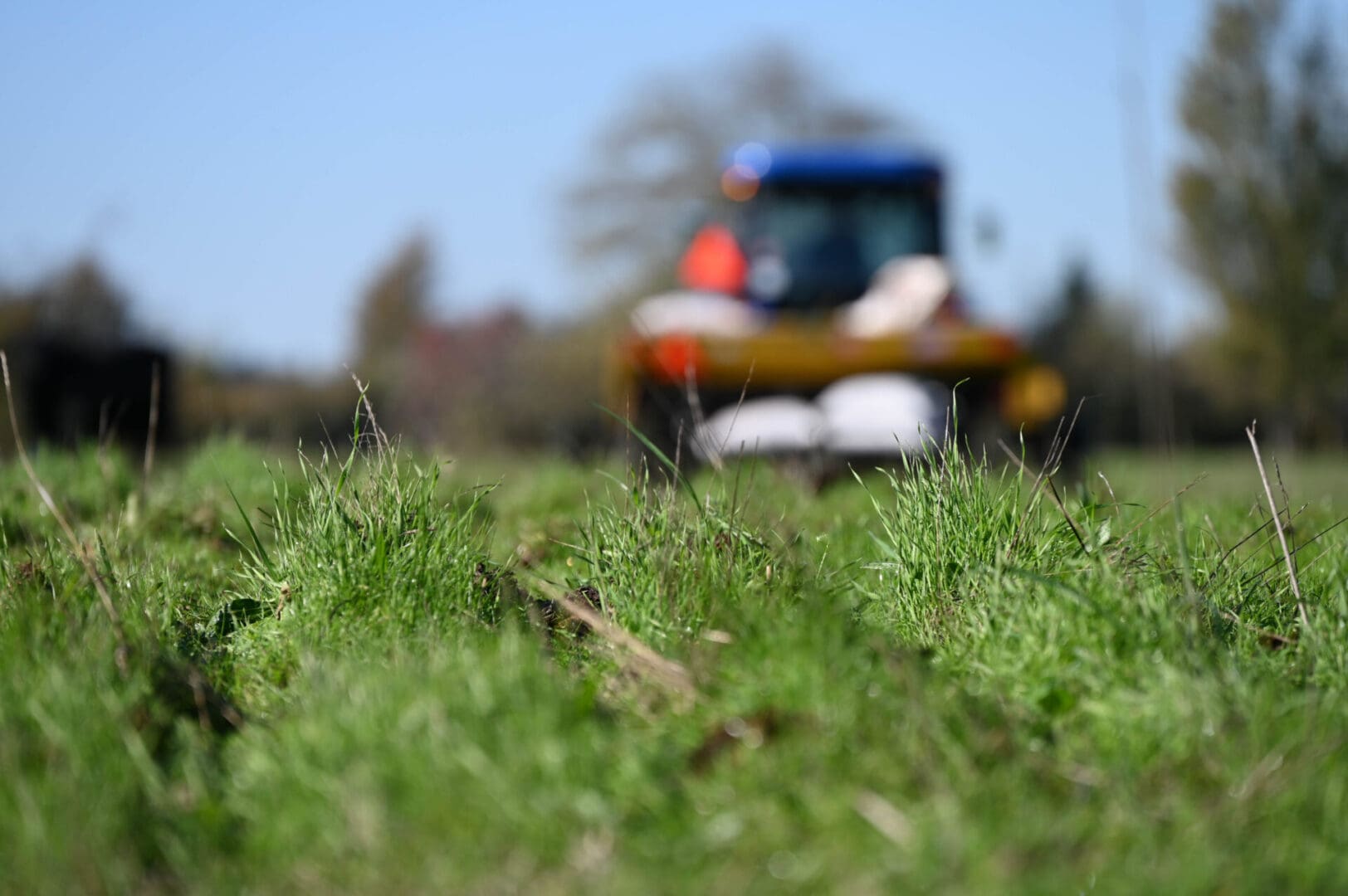 A tractor is mowing the grass in a field.