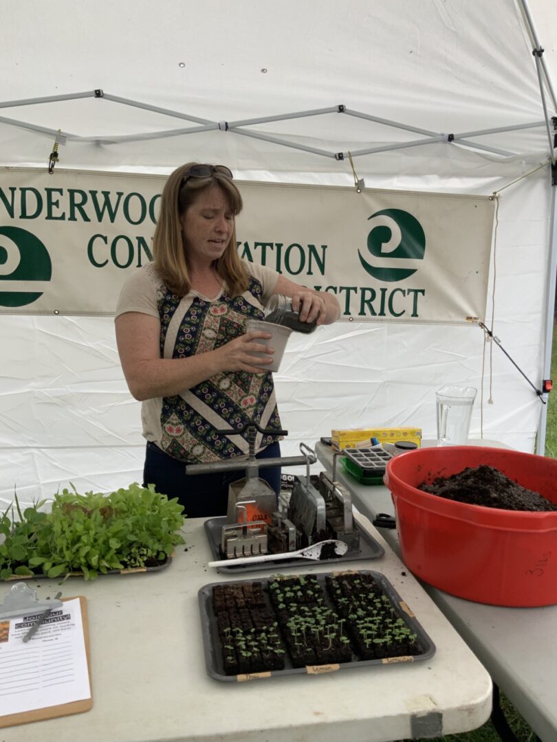 Volunteer Sarah Owens teaches about using soil blocker tools at the Underwood Conservation District Farm Tool Library, which received funding through SFF in Fiscal Year 2023.