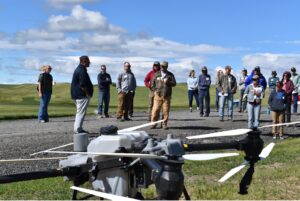 a drone with people standing in the background.