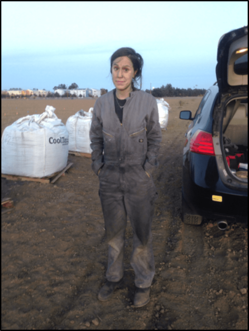 a person standing in a field with dust on them.