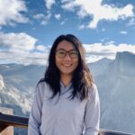 a person standing in front of mountains.