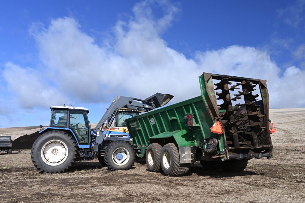 Loading compost into the spreader (photo by Leslie Michel, WSDA)