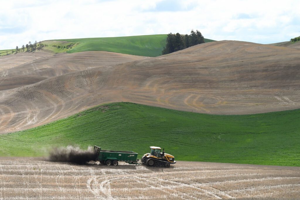 Spreading compost on hill tops (photo by Leslie Michel, WSDA)