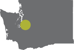 A map of Washington state with a dot on Puyallup, Washington.